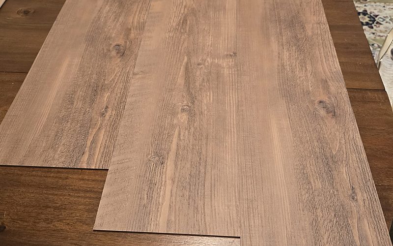 Russett glue-down LVT planks laid side by side, warm brown wood look